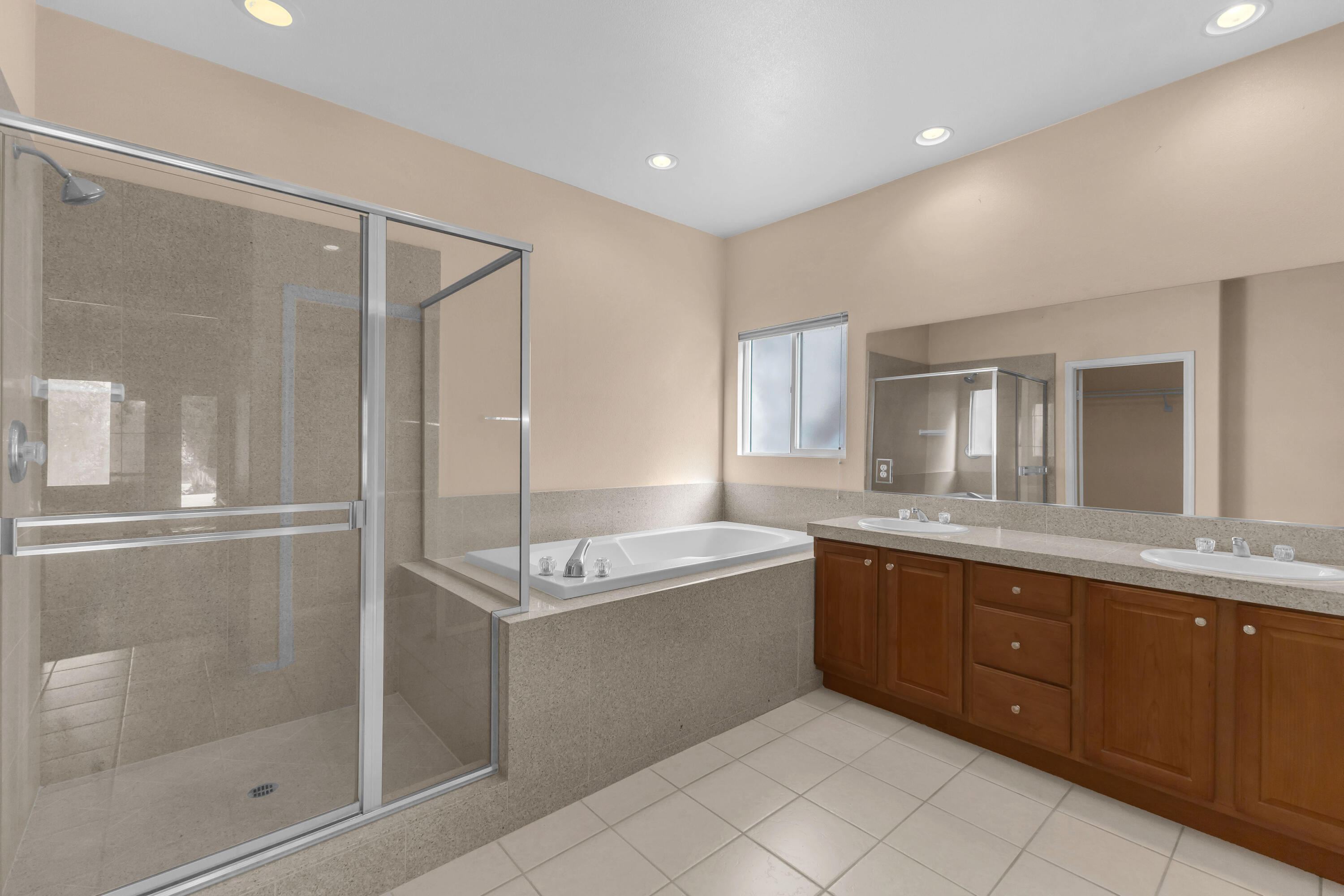 48690 Hepburn Drive Indio, CA 92201 - Photo 10 of 36 a spacious bathroom with a granite countertop sink mirror and bathtub