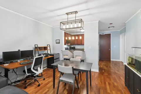 a view of a dining room with furniture and wooden floor