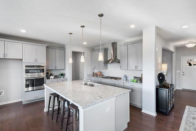 4331 Little Leaf Road Naperville, IL 60564 - Photo 2 of 39 a kitchen with stainless steel appliances granite countertop a sink stove and refrigerator