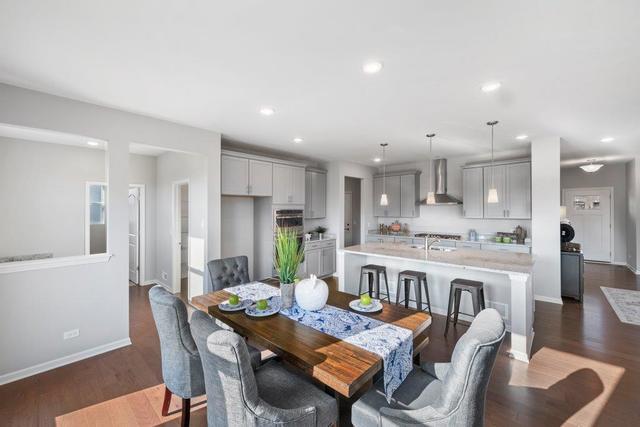 4331 Little Leaf Road Naperville, IL 60564 - Photo 11 of 39 a large kitchen with kitchen island a dining table and chairs