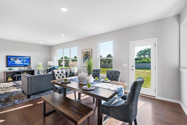 4331 Little Leaf Road Naperville, IL 60564 - Photo 15 of 39 a view of a dining room with furniture a large window and wooden floor