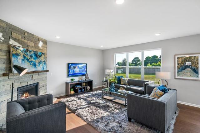 4331 Little Leaf Road Naperville, IL 60564 - Photo 16 of 39 a living room with furniture a large window and a fireplace