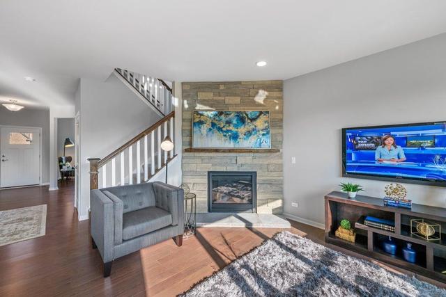 4331 Little Leaf Road Naperville, IL 60564 - Photo 17 of 39 a living room with furniture and a fireplace