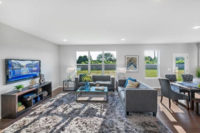 4331 Little Leaf Road Naperville, IL 60564 - Photo 19 of 39 a living room with furniture and a flat screen tv