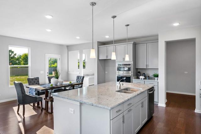 4331 Little Leaf Road Naperville, IL 60564 - Photo 3 of 39 a kitchen with a center island appliances and cabinets