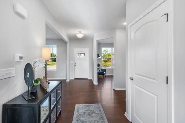 4331 Little Leaf Road Naperville, IL 60564 - Photo 22 of 39 a hallway with a dining table chairs and painted walls