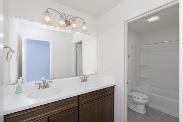 4331 Little Leaf Road Naperville, IL 60564 - Photo 32 of 39 a bathroom with a sink a toilet and shower