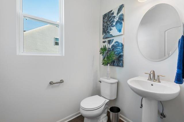 4331 Little Leaf Road Naperville, IL 60564 - Photo 33 of 39 a bathroom with a toilet a sink and mirror