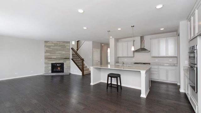 4331 Little Leaf Road Naperville, IL 60564 - Photo 7 of 39 a kitchen with stainless steel appliances granite countertop a stove a sink dishwasher a refrigerator and white cabinets with wooden floor