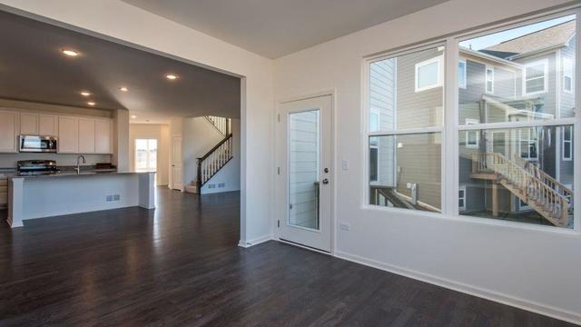 4331 Little Leaf Road Naperville, IL 60564 - Photo 10 of 39 a view of a big room with wooden floor and windows