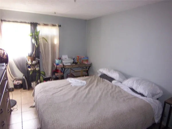 a bedroom with a bed and flat screen tv
