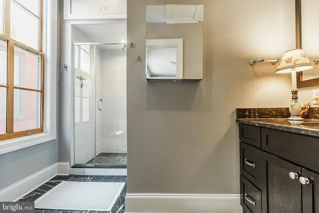a bathroom with a tub shower vanity and a sink