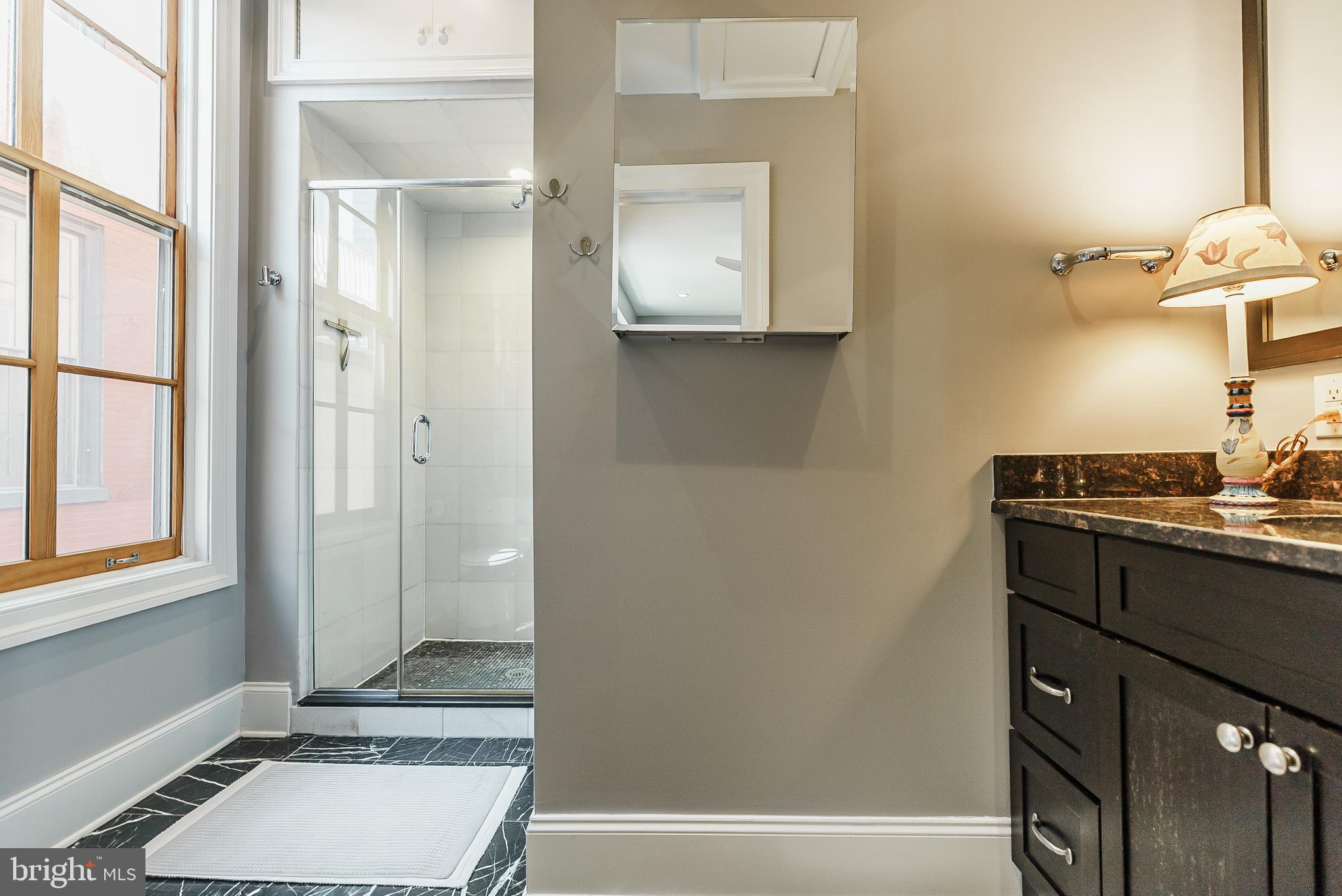 2049 Walnut Street, Unit 1R Philadelphia, PA 19103 - Photo 17 of 20 a bathroom with a tub shower vanity and a sink