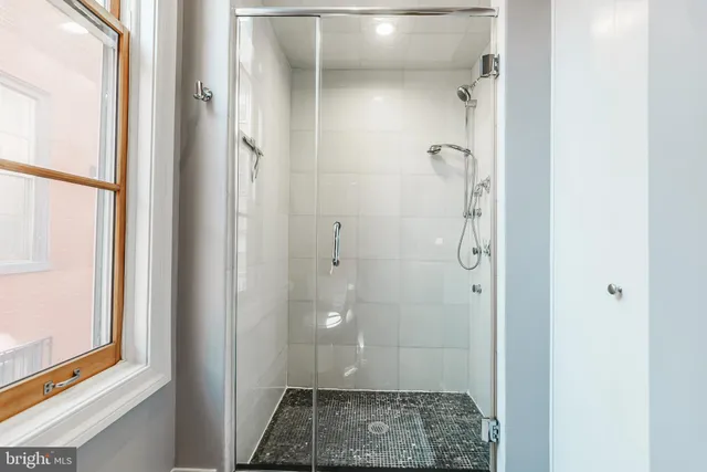 a bathroom with a granite countertop shower