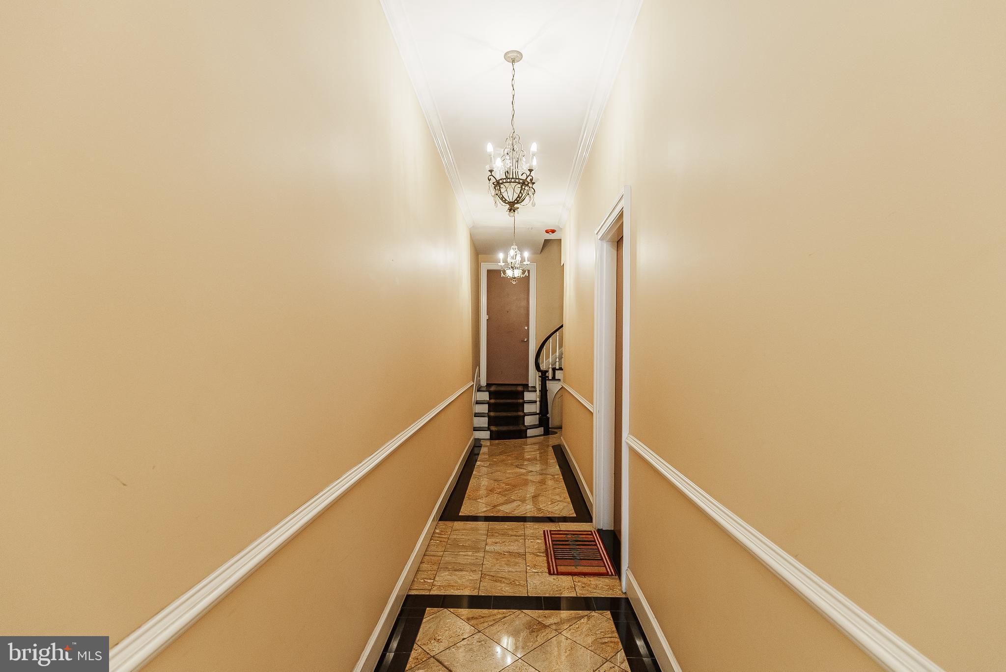 2049 Walnut Street, Unit 1R Philadelphia, PA 19103 - Photo 3 of 20 a view of a hallway with wooden floor and staircase