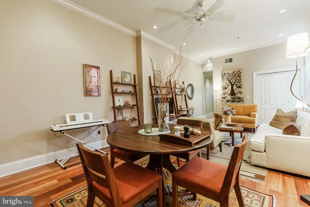a view of a dining room with furniture and wooden floor