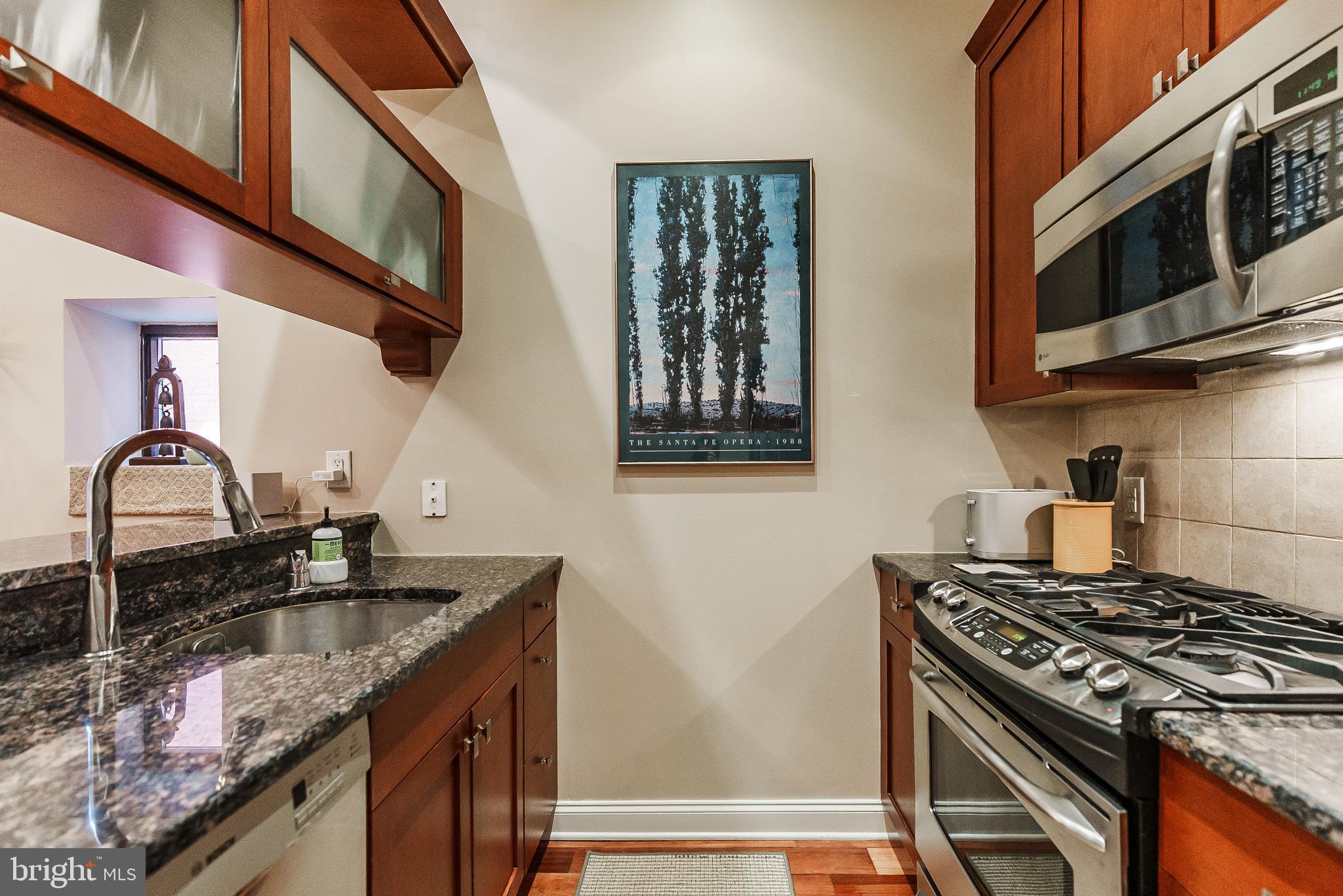 2049 Walnut Street, Unit 1R Philadelphia, PA 19103 - Photo 10 of 20 a kitchen with granite countertop a sink stove and cabinets