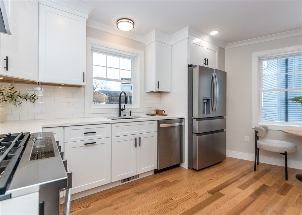 89 Hardy Pond Road Waltham, MA 02451 - Photo 11 of 39 a kitchen with a refrigerator a stove a sink and a window