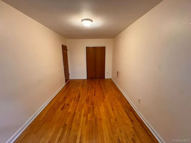 wooden floor in a hall with a window