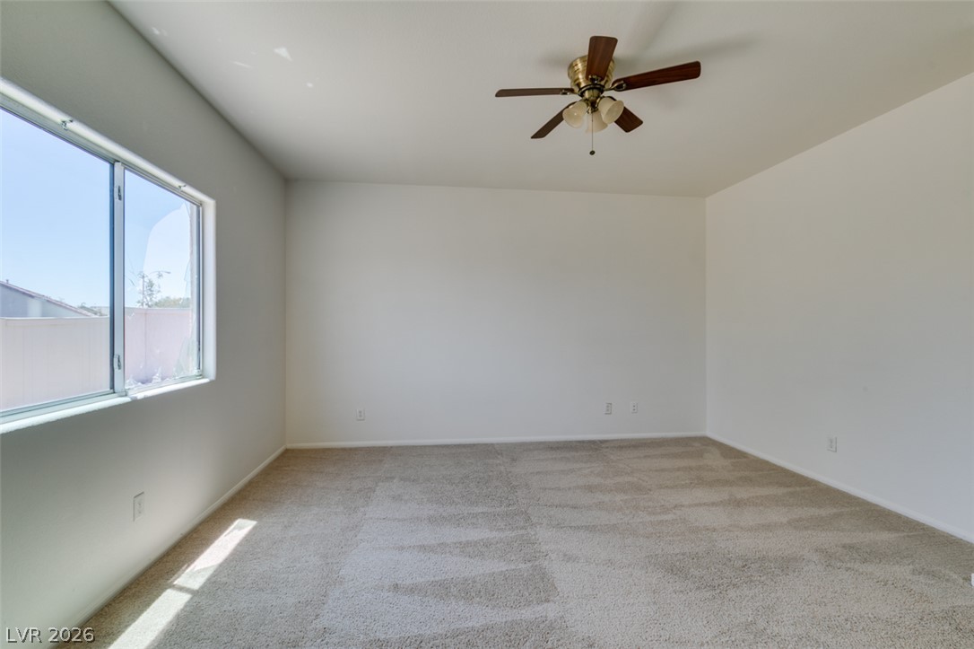 5150 Riverside Run Court North Las Vegas, NV 89081 - Photo 40 of 50 A spacious room offers ample natural light and plush carpeting underfoot.