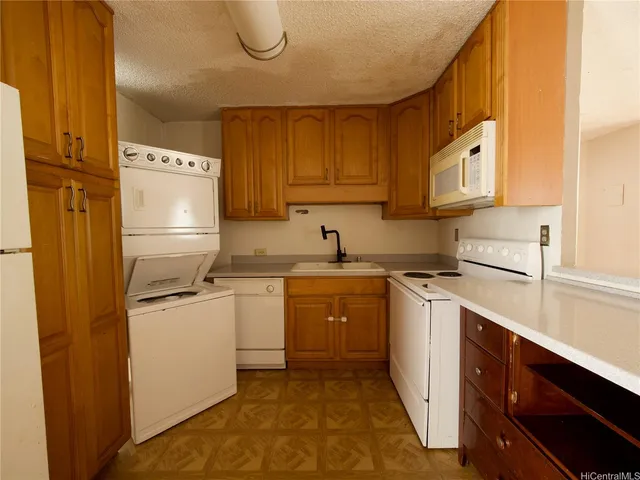 a kitchen with a sink a stove and refrigerator