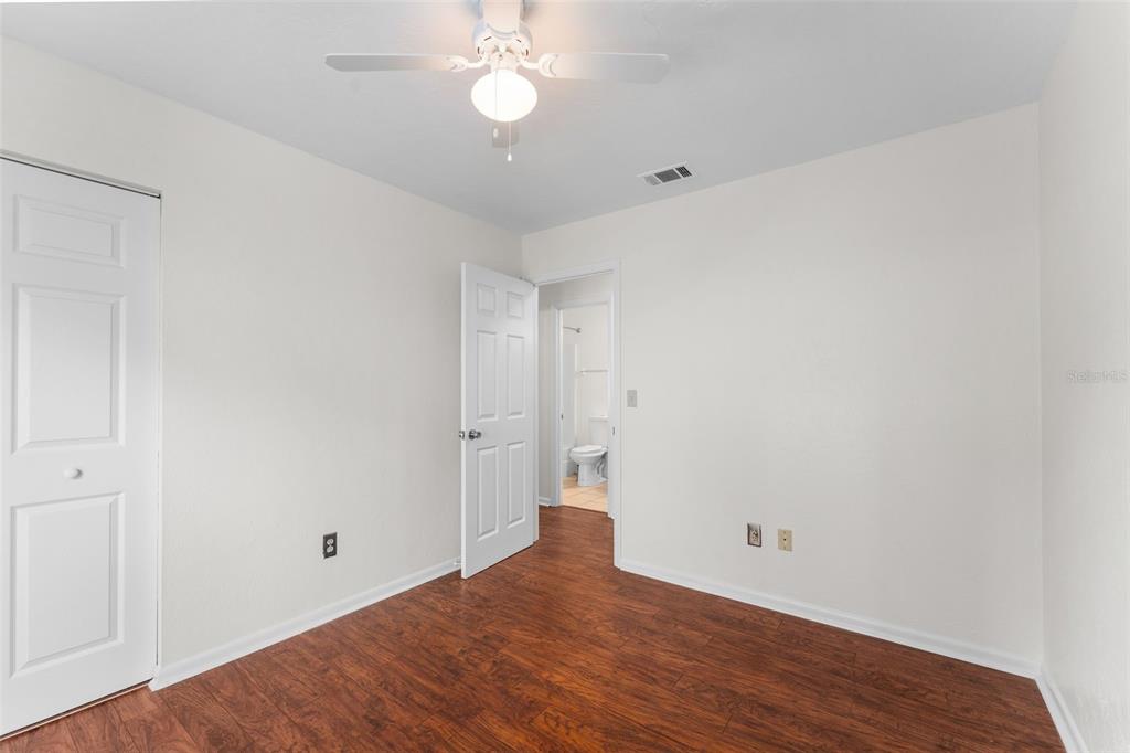 2026 Southwest 73rd Street Gainesville, FL 32607 - Photo 16 of 20 a view of an empty room with wooden floor