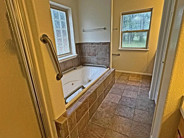 a spacious bedroom with a bed and a large window