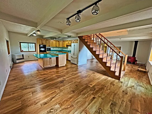 a wooden door in front of a house with a small yard