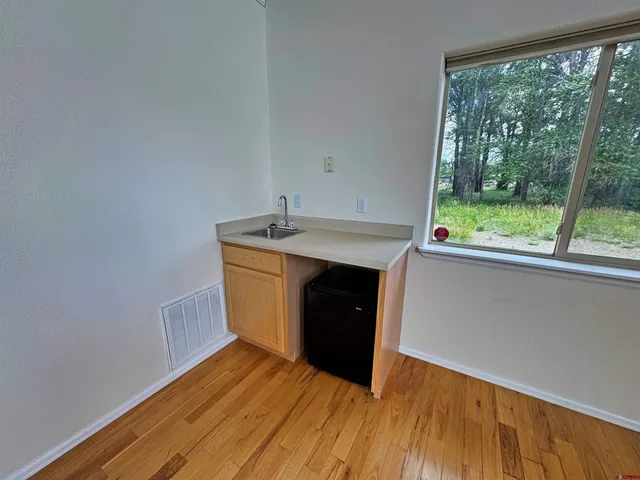 a view of walk in closet with empty racks