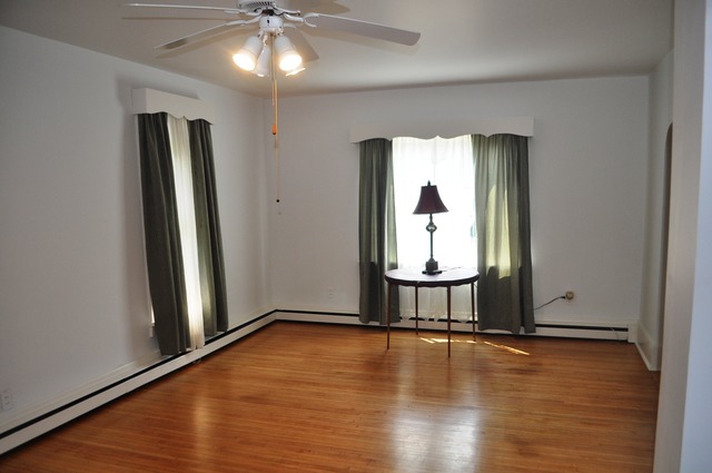 456 Franklin Boulevard Elgin, IL 60120 - Photo 3 of 14 a view of empty room with window and wooden floor