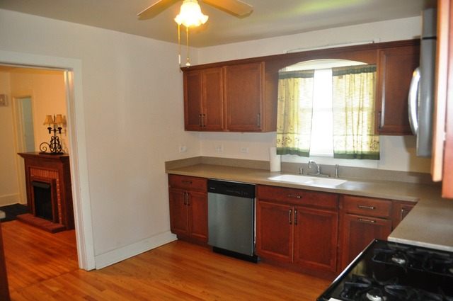 456 Franklin Boulevard Elgin, IL 60120 - Photo 5 of 14 a kitchen with a sink cabinets and wooden floor