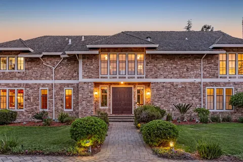 a front view of a house with garden
