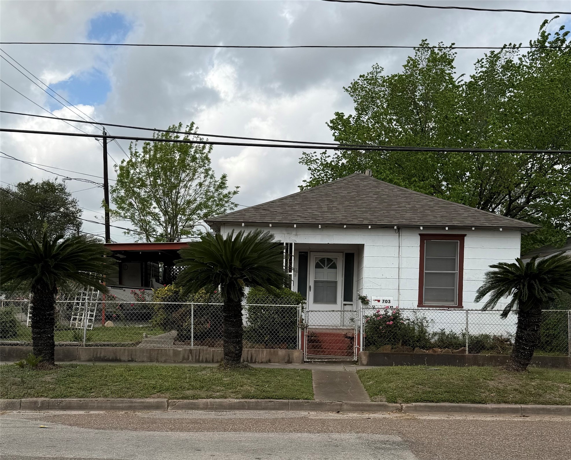 703 76th Street Houston, TX 77012 - Photo 2 of 23 a front view of a house with a garden
