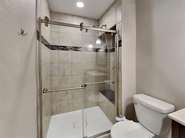 a bathroom with a shower and toilet