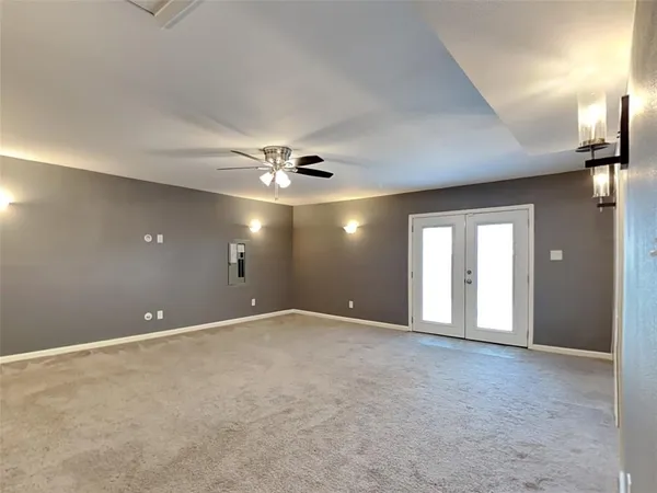 a view of an empty room with a ceiling fan