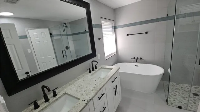 a bathroom with double vanity sink and mirror