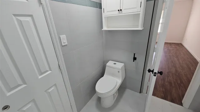 a white toilet sitting next to a sink