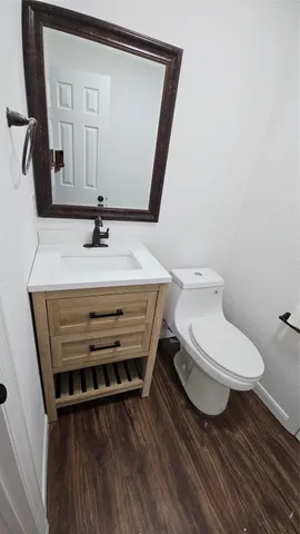 a bathroom with a toilet a sink and mirror