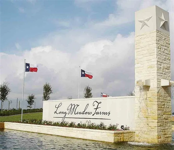 a street sign on a wall next to a road