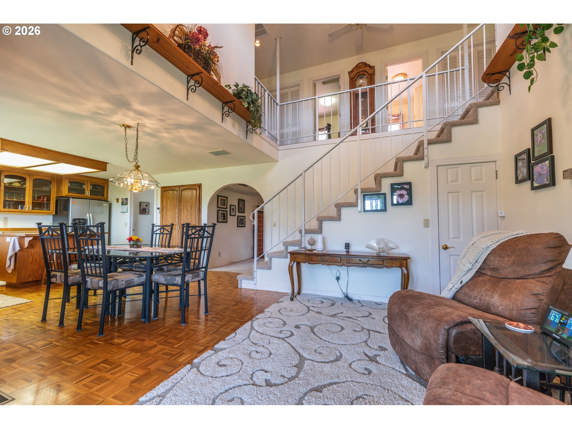 489 Fir Vista Road Sutherlin, OR 97479 - Photo 4 of 47 a living room with couches a dining table and chairs with wooden floor