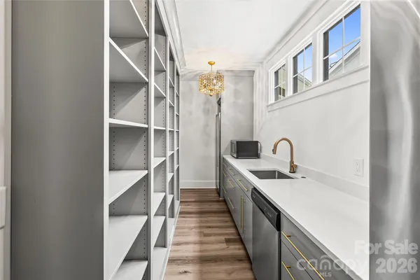 a hallway with sink and mirror