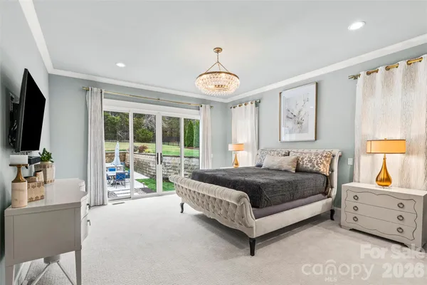 a spacious bedroom with a bed and a tv