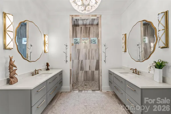 a spacious bathroom with a double vanity sink a mirror and a bathtub