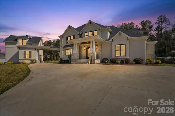 a front view of a building with cars parked