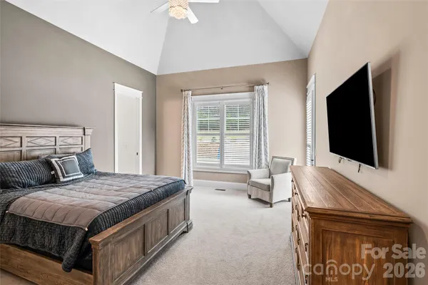 a bedroom with a bed and a flat screen television