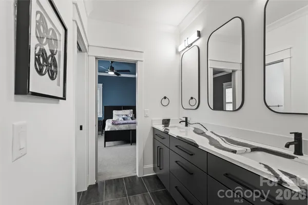 a en suite bathroom with a double vanity sink and a mirror
