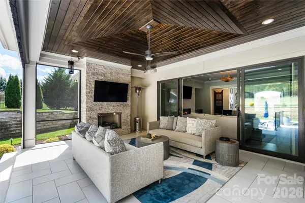 a living room with patio furniture and a fireplace