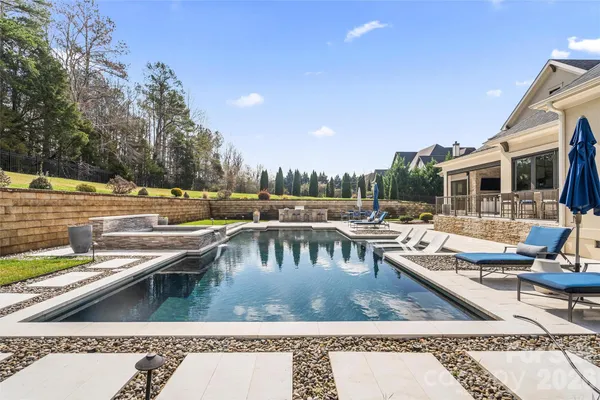 a view of swimming pool with outdoor seating