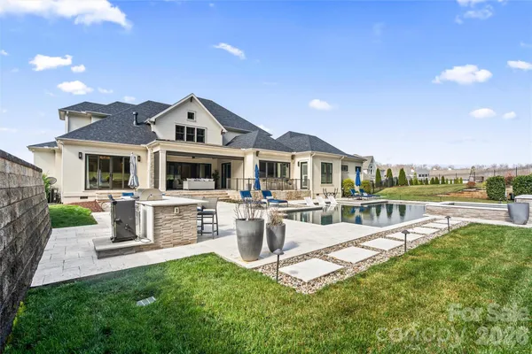 a front view of a house with swimming pool and porch