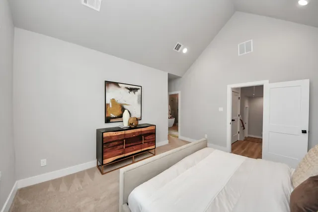 a bedroom with a bed and a large mirror